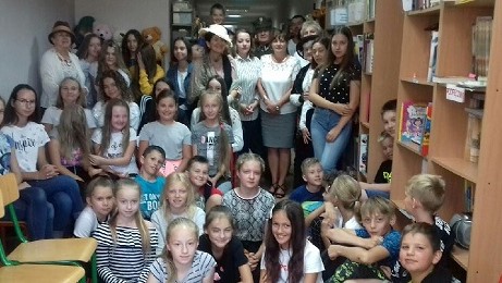Zdjęcie grupowe wszystkich uczestników wydarzenia. Każda osoba trzyma książki.